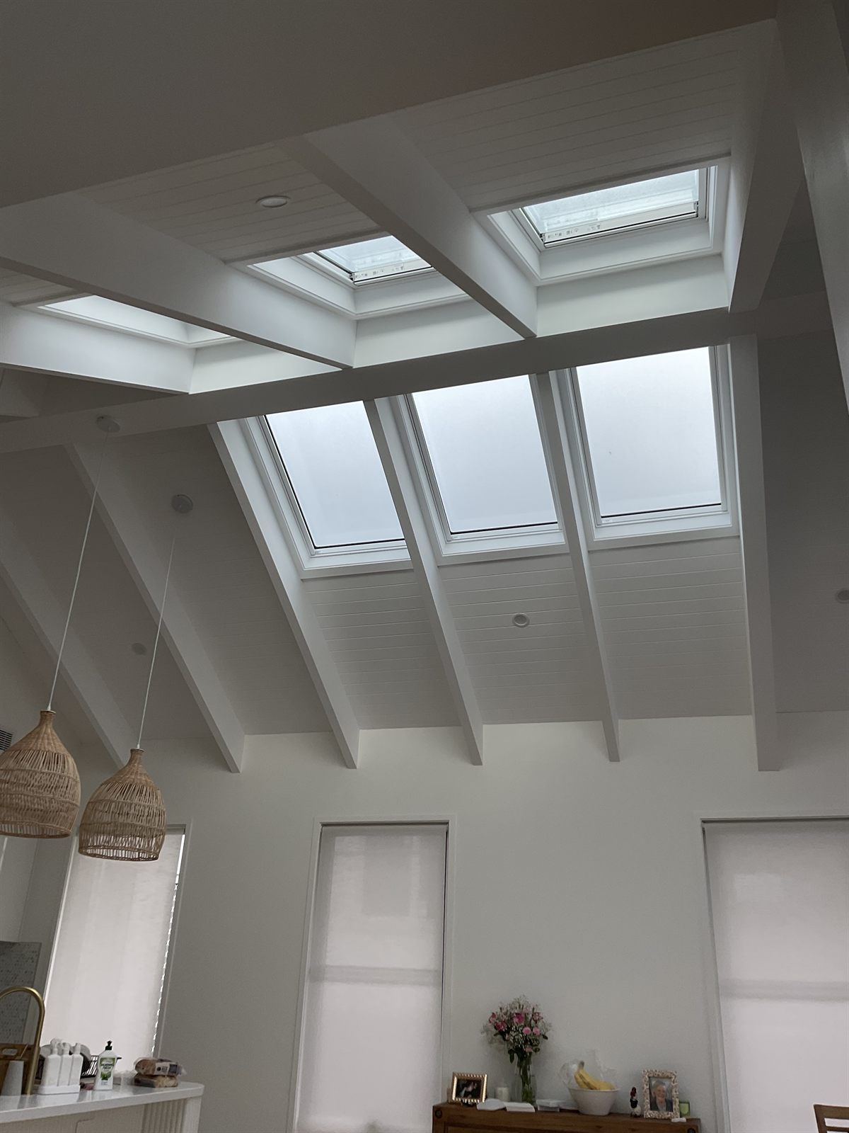 A bright vaulted living room lit by a row of Velux skylights in a Northern Rivers home