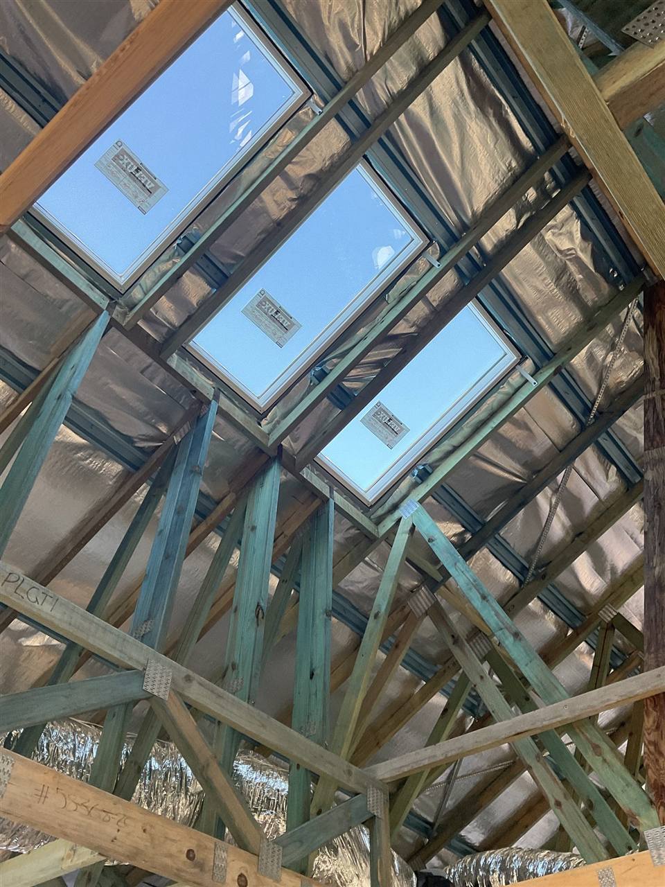 Skylight openings framed against the sky during an installation