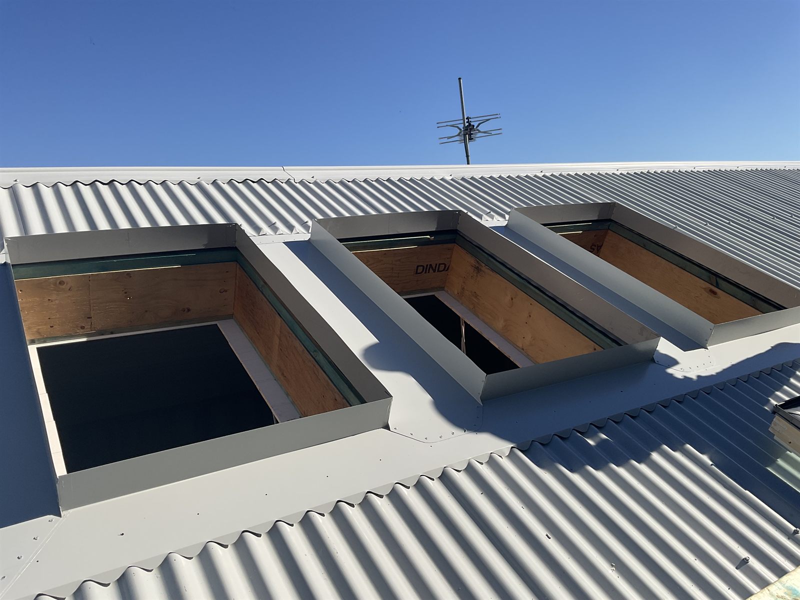 Roof openings cut and prepared during a skylight replacement on a Colorbond roof