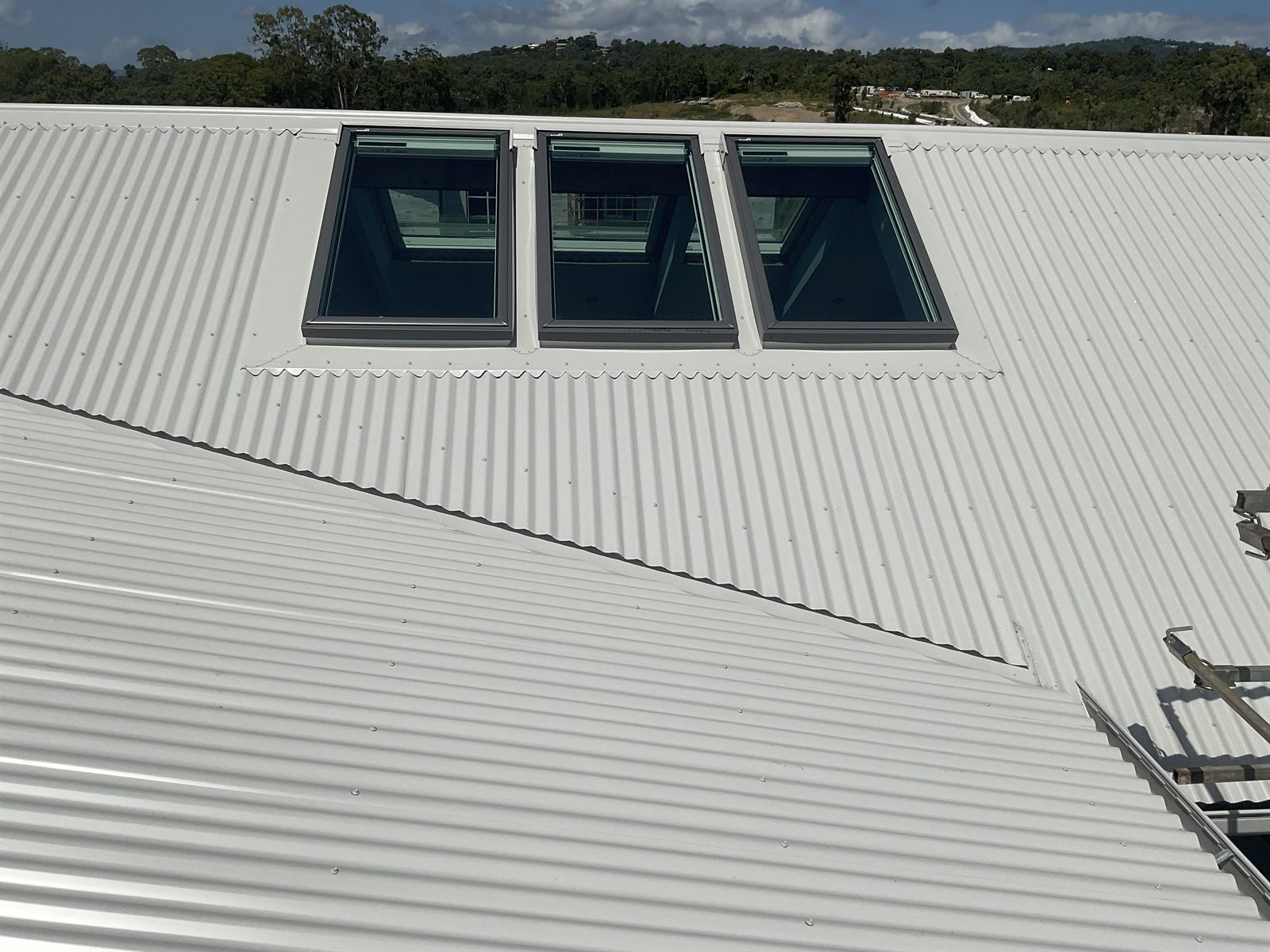 Three Velux skylights installed in a white Colorbond roof by Northern Rivers Skylights