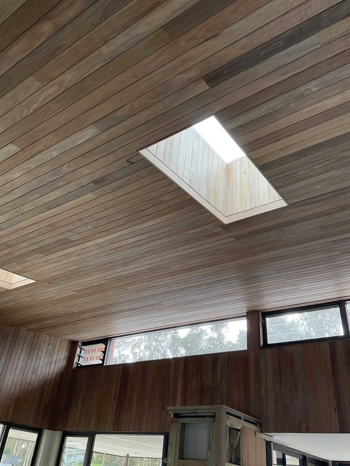 A Velux skylight set into a timber-lined ceiling, bringing light and air into the room